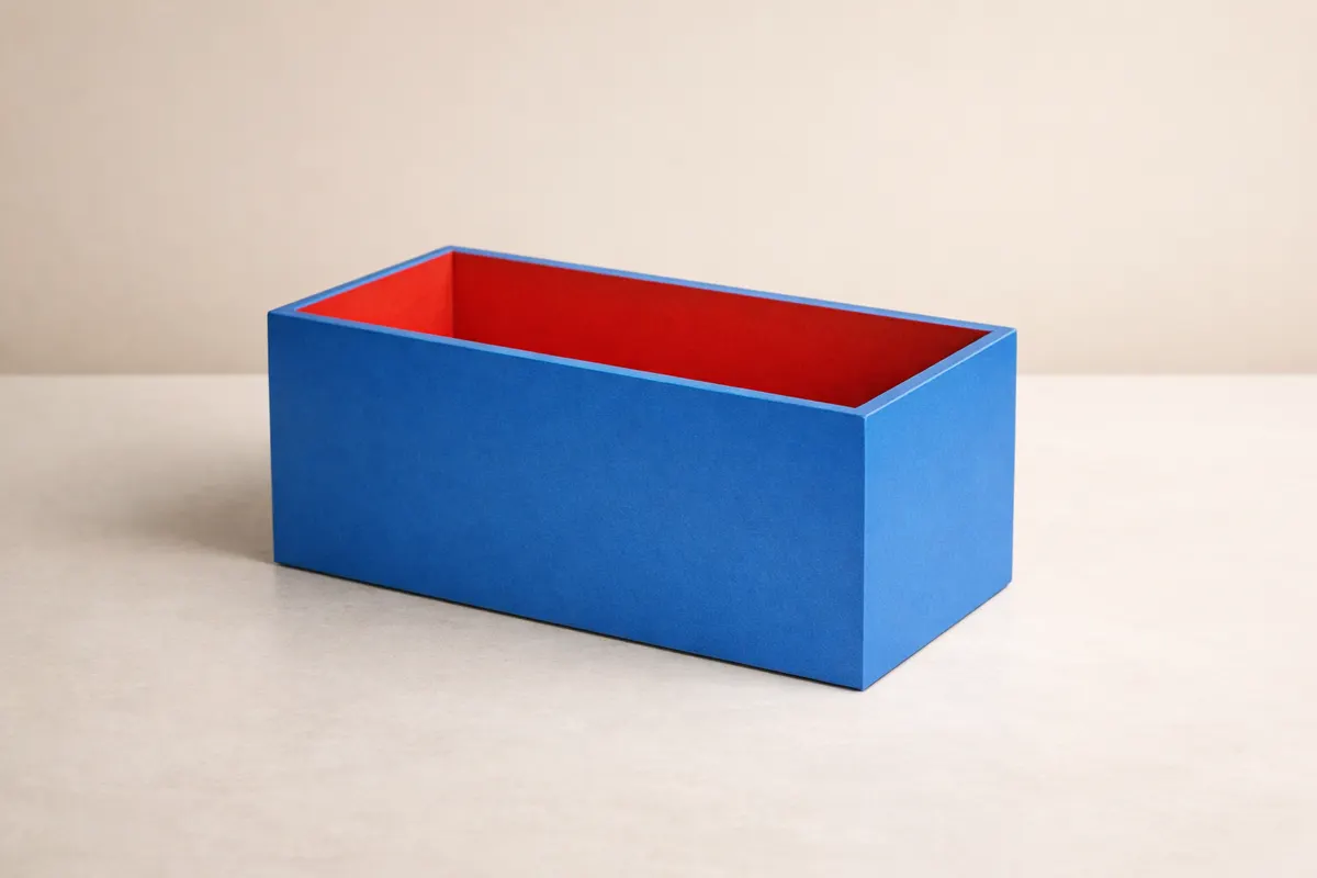 Open rectangular box with blue exterior faces and a red interior, illustrating outside surface and inside capacity.